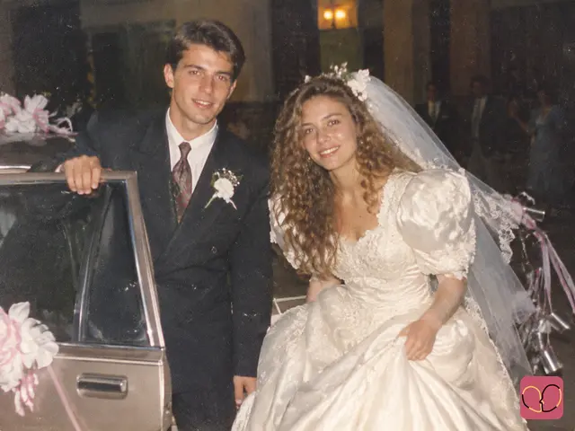1980s couple photo — Newlyweds laugh beside their decorated wedding car as they get ready to leave